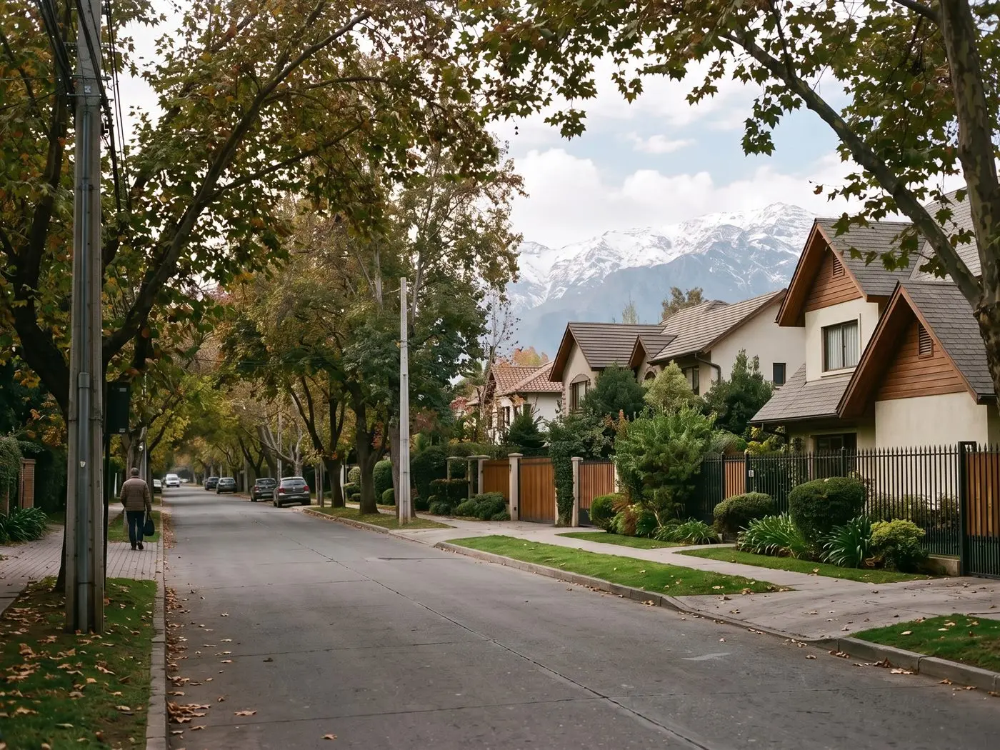Calle arbolada de La Reina con casas grandes, antejardines y la cordillera nevada al fondo